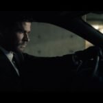 Crime 101 movie scene featuring Chris Hemsworth inside a vehicle