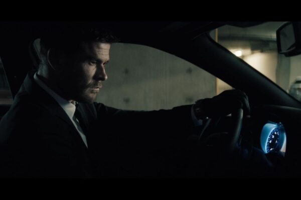 Crime 101 movie scene featuring Chris Hemsworth inside a vehicle